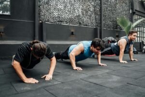 Men performing push-ups during a group workout session in Mexico City gym.