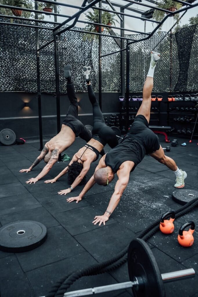 Three people engaged in a dynamic workout session in a Mexico City gym, showcasing fitness and teamwork.